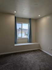 Carpeted empty room featuring recessed lighting and a textured ceiling