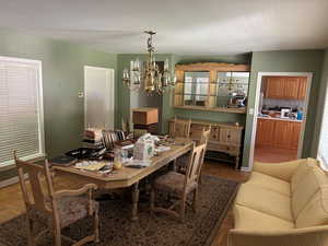 Dining space featuring a chandelier and baseboards