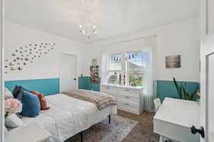 Bedroom with a chandelier and carpet