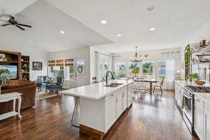 Kitchen featuring open floor plan, stainless steel appliances, dark wood finished floors, healthy amount of natural light, and recessed lighting