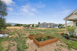 View of yard featuring a vegetable garden and a mountain view