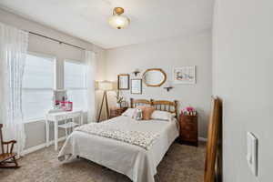 Carpeted bedroom with baseboards