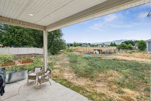 View of yard featuring a patio area, a vegetable garden, and a mountain view