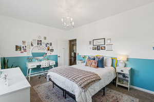 Bedroom featuring a chandelier, carpet flooring, and baseboard heating