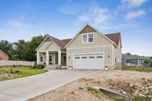 Craftsman inspired home featuring board and batten siding, covered porch, concrete driveway, a garage, and a shingled roof