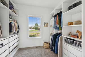 Spacious closet with carpet floors