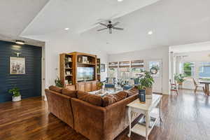 Living area with hardwood / wood-style floors, vaulted ceiling, ceiling fan, recessed lighting, and a textured ceiling