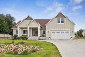 Craftsman-style house with board and batten siding, roof with shingles, concrete driveway, a porch, and a garage