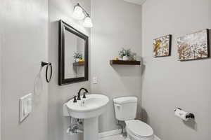 Bathroom featuring toilet and baseboards