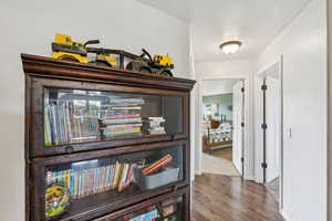 Hallway featuring wood finished floors and a textured ceiling
