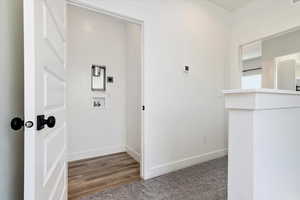 Corridor featuring wood finished floors and carpet floors