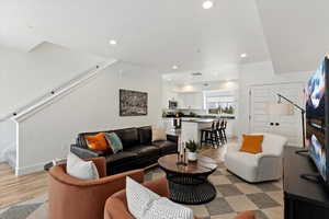 Living room featuring stairway, recessed lighting, and light wood-style floors