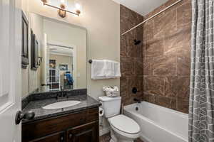Bathroom with shower / bath combo and vanity