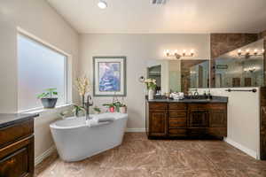 Full bathroom with vanity, a soaking tub, a tile shower, and marble finish flooring