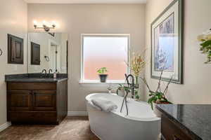 Bathroom with vanity and a freestanding bath