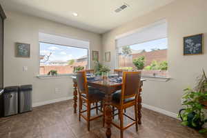 Dining space with baseboards and recessed lighting