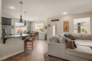 Living area with recessed lighting and dark tile patterned floors