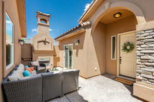 View of patio with an outdoor living space with a fireplace