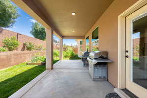 Fenced backyard featuring a patio area and area for grilling