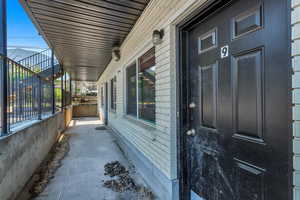 View of exterior entry featuring brick siding