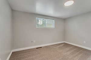 Unfurnished room featuring carpet