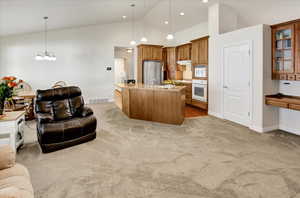 Kitchen with open floor plan and walnut cabinets