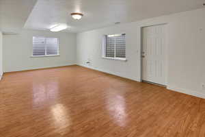 Basement room plumbed for kitchen sink, outlets installed for stove and a laundry room, wood finished floors, walk out and healthy amount of natural light.