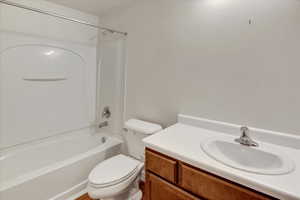 Bathroom with bathing tub / shower combination and vanity.