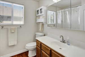 Bathroom featuring wood finished floors, vanity, and a shower.