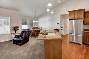 Kitchen featuring freestanding refrigerator.