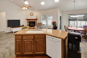 Kitchen with white dishwasher, open floor plan, plenty of natural light, and ceiling .