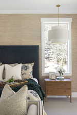 Carpeted bedroom with multiple windows and crown molding