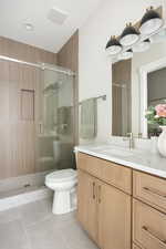 Full bath featuring vanity, tile patterned flooring, and a stall shower