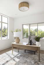 Home office with wood finished floors and baseboards