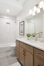 Bathroom featuring vanity, bathing tub / shower combination, and tile patterned flooring