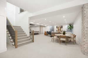 Dining area featuring stairs, recessed lighting, and light colored carpet
