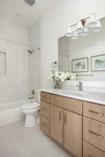 Full bathroom featuring vanity, shower / bath combination, and tile patterned flooring