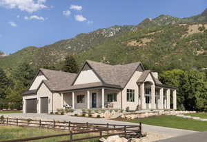 Modern inspired farmhouse featuring a porch, a mountain view, brick siding, and concrete driveway