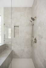 Full bath with a tile shower