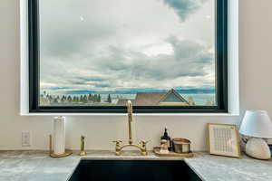 Kitchen view of a sink and light countertops