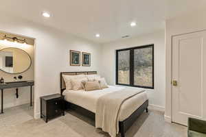 Bedroom with light carpet and recessed lighting