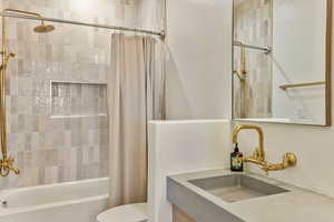 Full bathroom featuring shower / tub combo and vanity