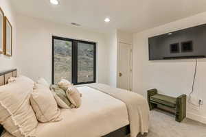Bedroom featuring light carpet and recessed lighting
