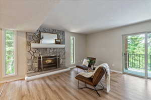 Living area with wood finished floors and a fireplace