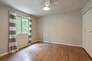 Spare room featuring light wood-type flooring and ceiling fan