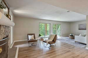 Living area featuring wood finished floors and a fireplace
