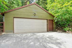 View of detached garage with a 240 Charger