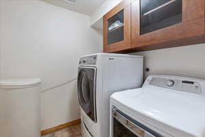 Laundry room with independent washer and dryer and cabinet space