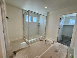 Full bath featuring healthy amount of natural light, a shower stall, and recessed lighting