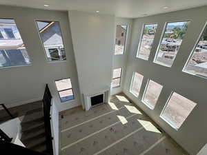 Unfurnished living room with recessed lighting and a high ceiling